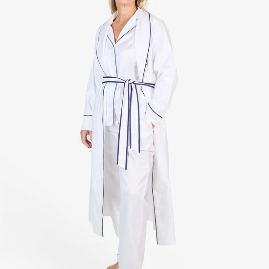 White herringbone organic cotton robe with navy trim long sleeves and front patch pocket