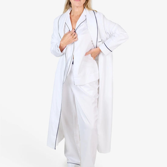 White herringbone organic cotton robe with navy trim long sleeves and front patch pocket