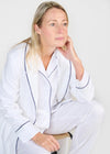 White herringbone organic cotton robe with navy trim long sleeves and front patch pocket