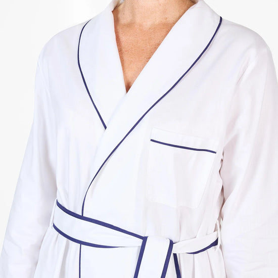 White herringbone organic cotton robe with navy trim long sleeves and front patch pocket