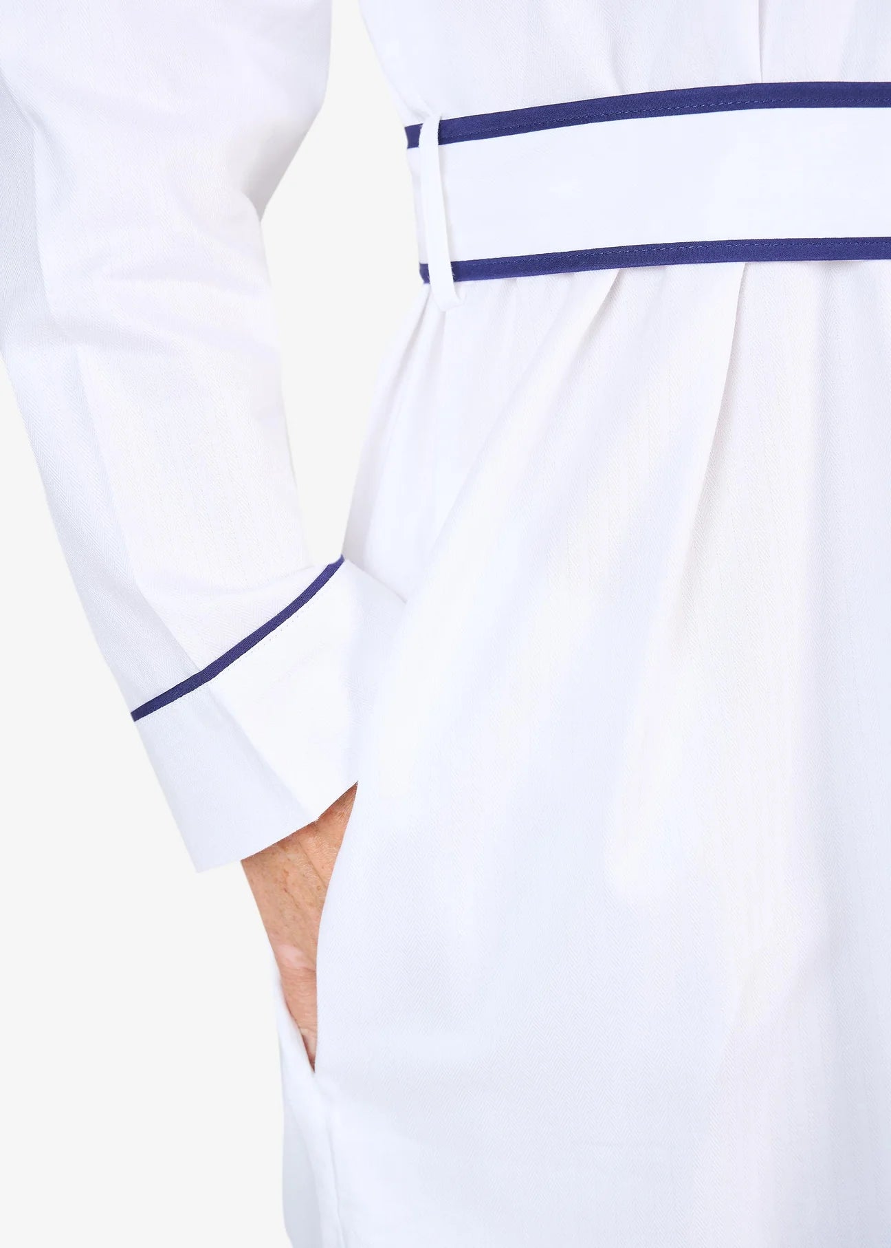 White herringbone organic cotton robe with navy trim long sleeves and front patch pocket