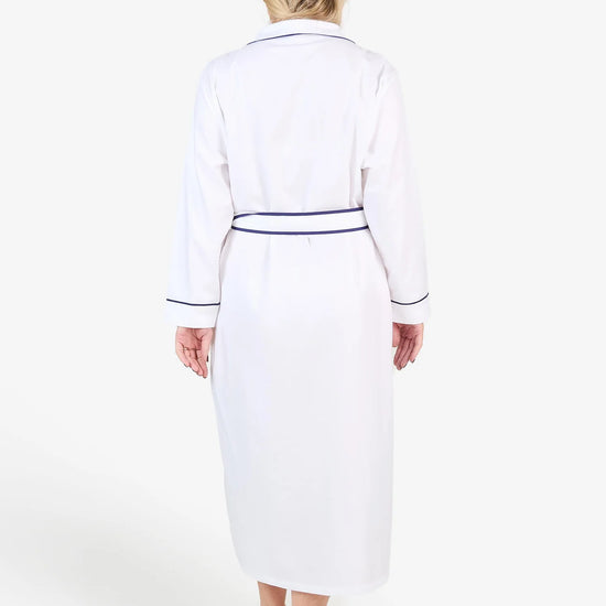 White herringbone organic cotton robe with navy trim long sleeves and front patch pocket