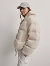 Faux fur padded cream jacket with knitted vertical welt pockets and full length gold metallic zip fastening with elasticated sleeves