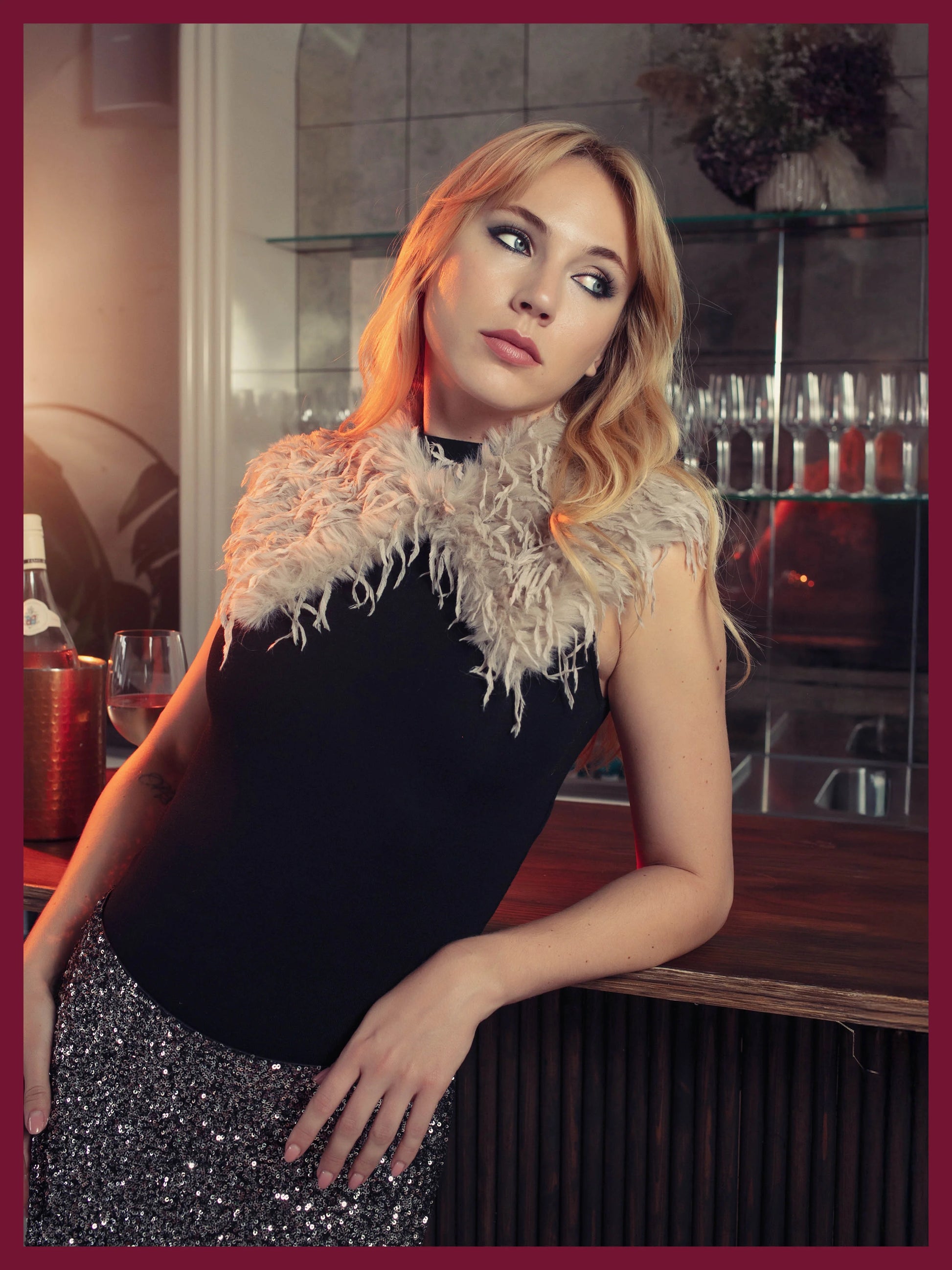 Woman in a stylish outfit with a feathered collar in a bar setting
