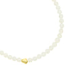 Necklace with white beads and a gold heart charm on a white background from Talis Chains