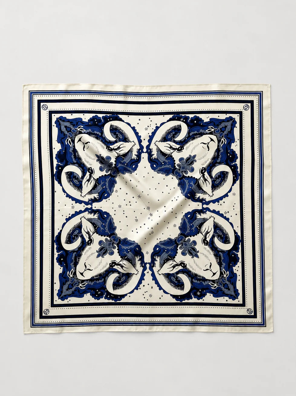 A square silk scarf with a classic blue and white baroque-style floral pattern, laid flat against a light gray background.