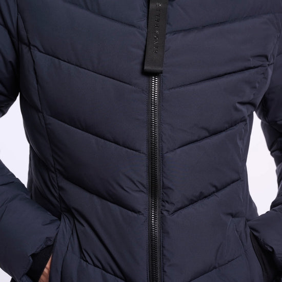 Close-up of a person wearing a black puffer jacket with a hood on a white background