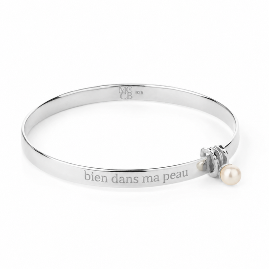 Silver bracelet with a pearl on a white background