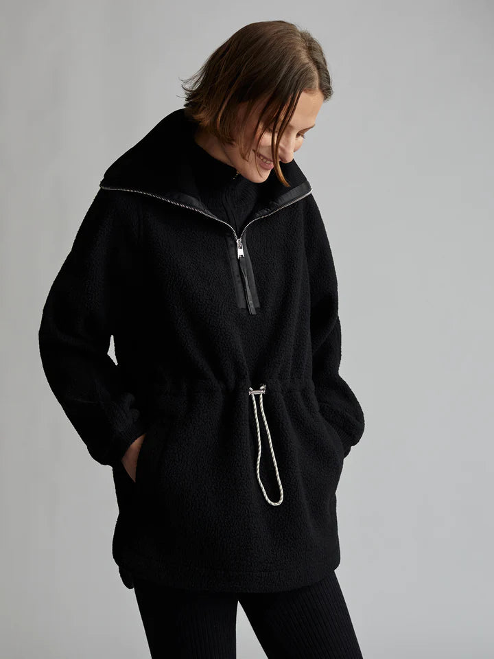 black fleece jacket with half zip fastening and drawstring rope waist fastening