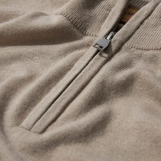 beige quarter zip knit with contrast stripe cuff close up
