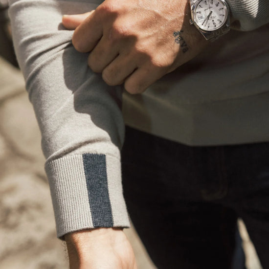 beige quarter zip knit with contrast stripe cuff close up on cuff