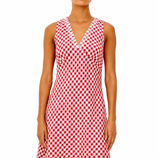 Woman wearing a red and white checkered dress on a white background