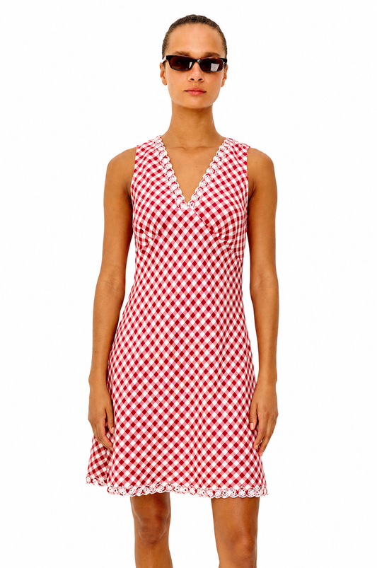 Woman wearing a red and white checkered dress on a white background