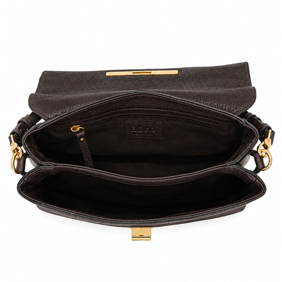 An open black leather shoulder bag with gold-tone hardware, showing its interior compartments, zipper pocket, and a small embossed brand label on the inner flap.