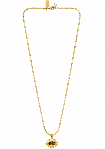 flat lay of a gold necklace with an evil eye pendant with a brown tigers eye stone on the pendant 