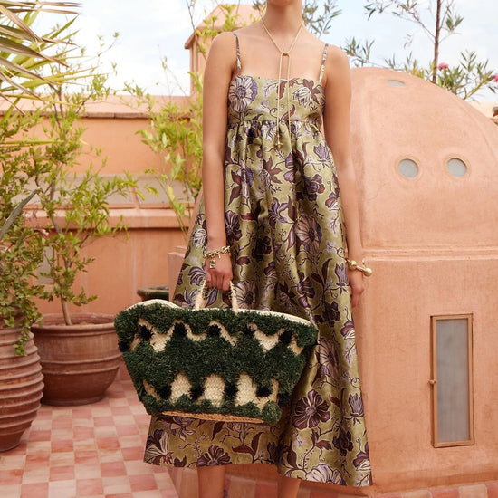 spaghetti strap mid length floral green dress from alemais model shot