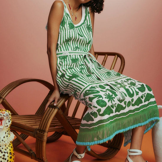 Sleeveless green printed sun dress with fringe detail on the hem