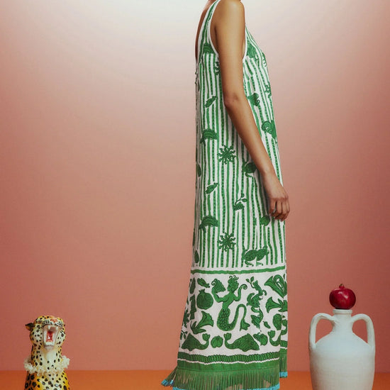 Sleeveless green printed sun dress with fringe detail on the hem side view 