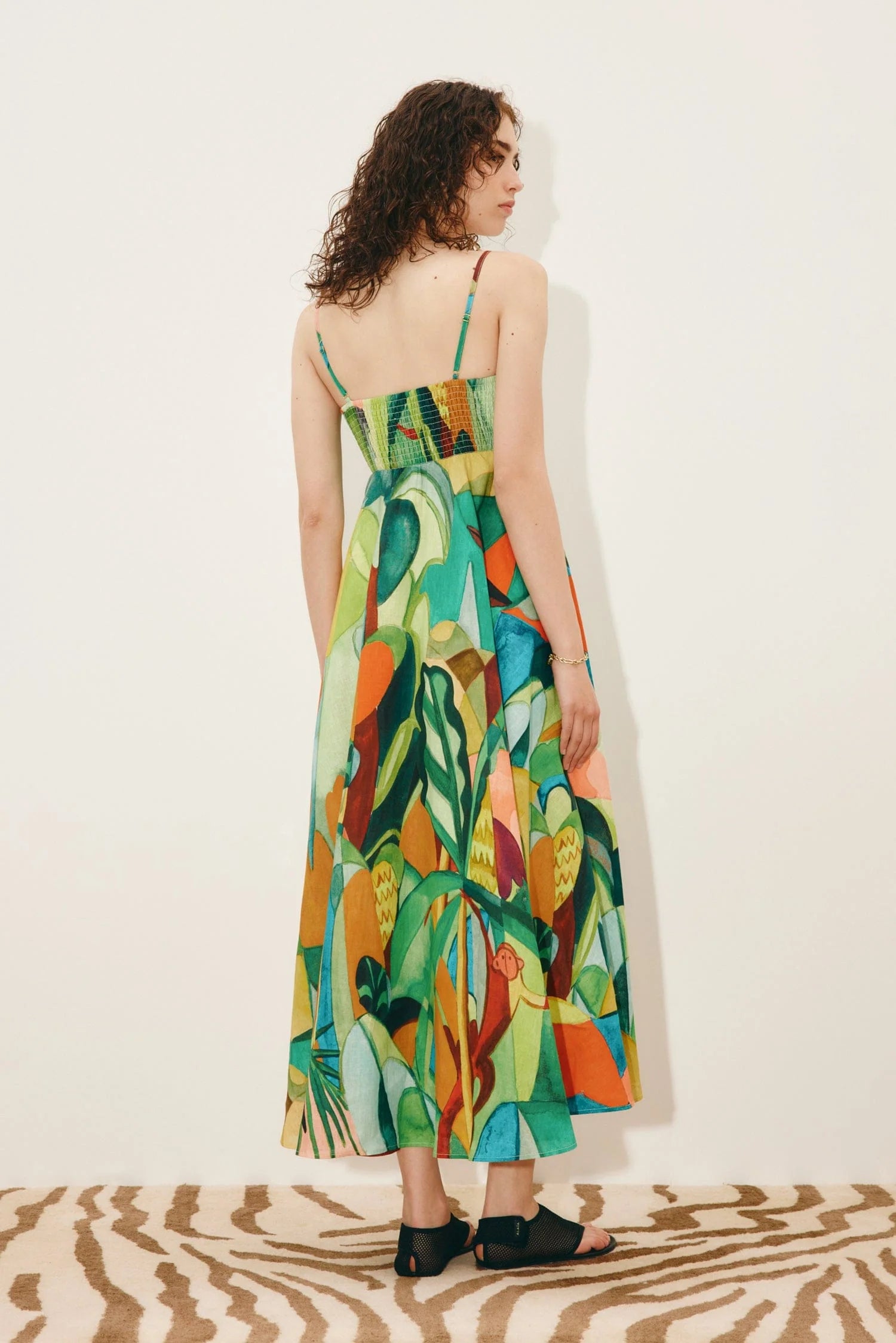 Rear view of green print linen dress in jungle design with smocked back from Alemais