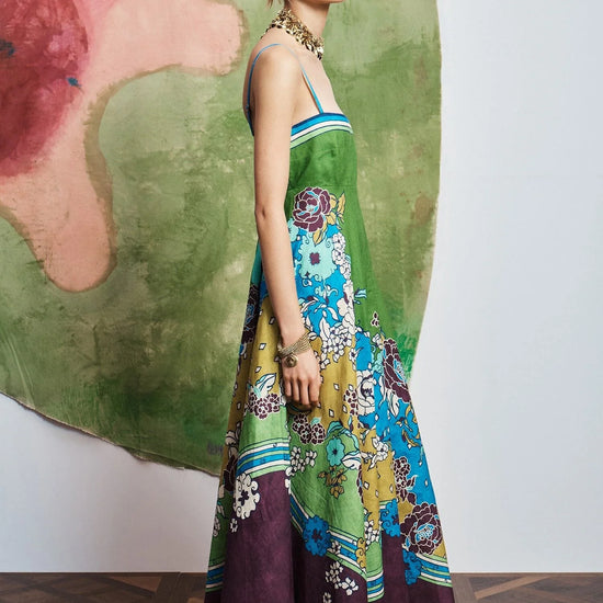 Woman wearing pattern maxi dress by Alemais side view
