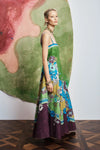 Woman wearing pattern maxi dress by Alemais side view