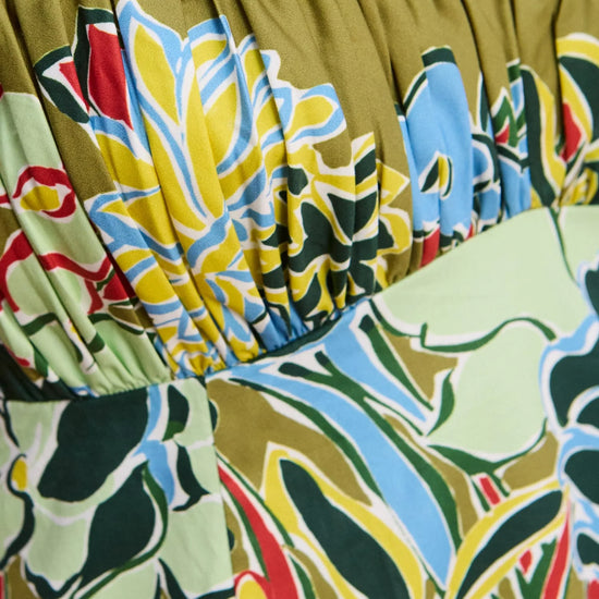 Close-up of a colorful floral dress with a green background