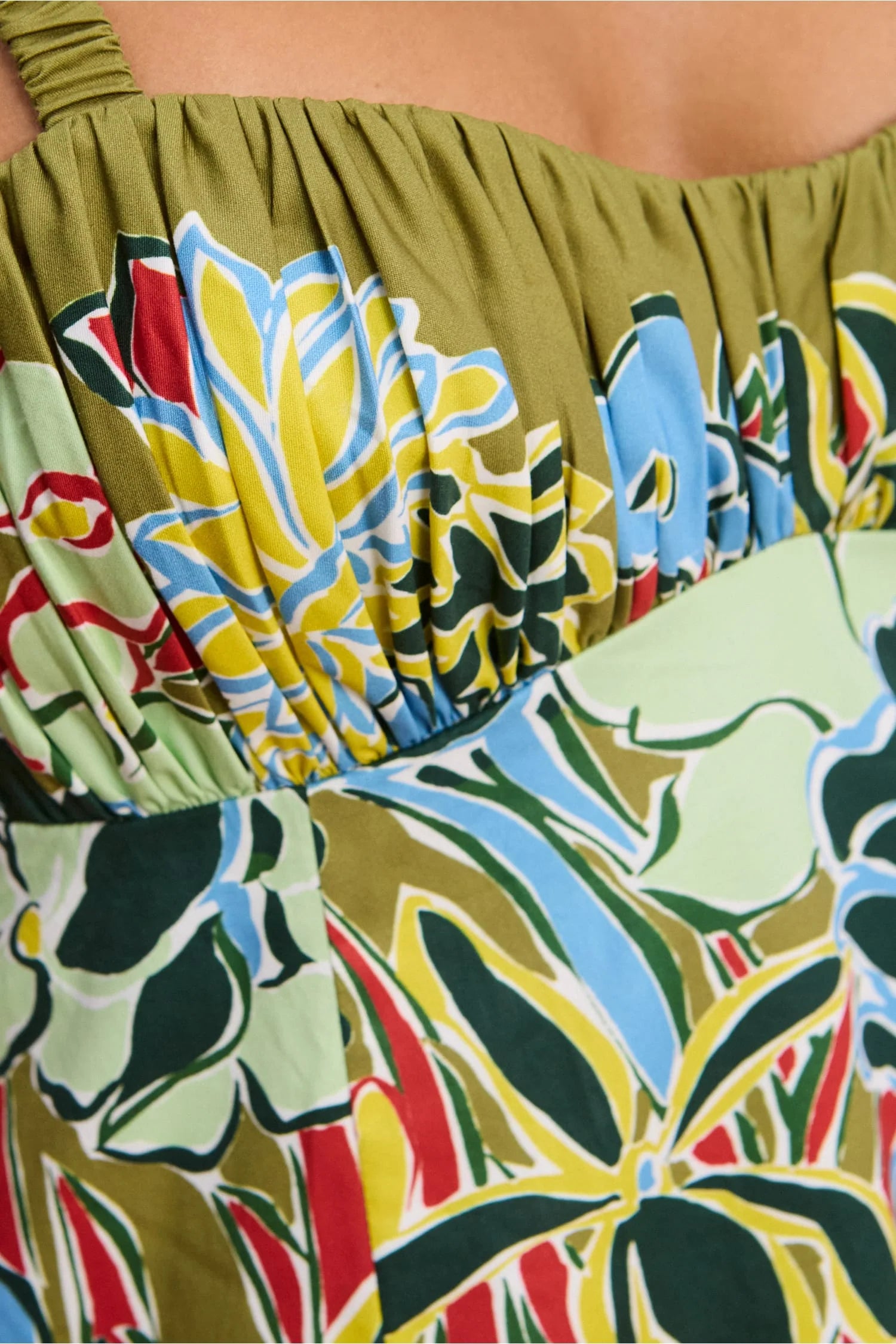 Close-up of a colorful floral dress with a green background