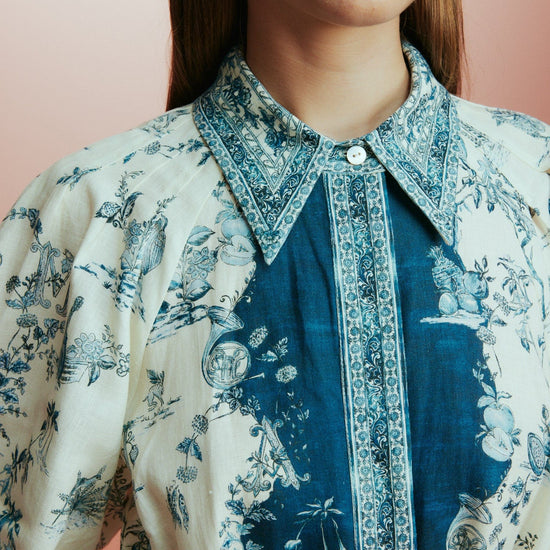 white shirtdress with blue delicate print and balloon sleeves with elasticated cuffs close up