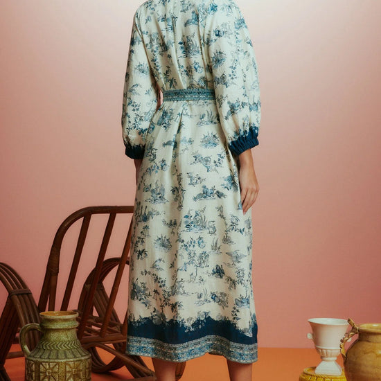 white shirtdress with blue delicate print and balloon sleeves with elasticated cuffs rear view 