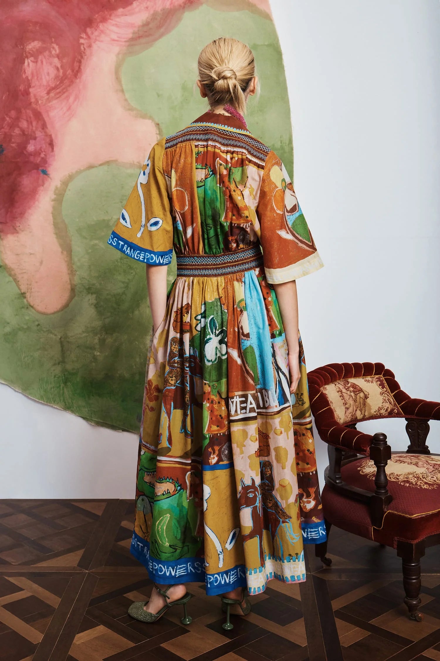 Woman wearing patterned Alemais dress rear view