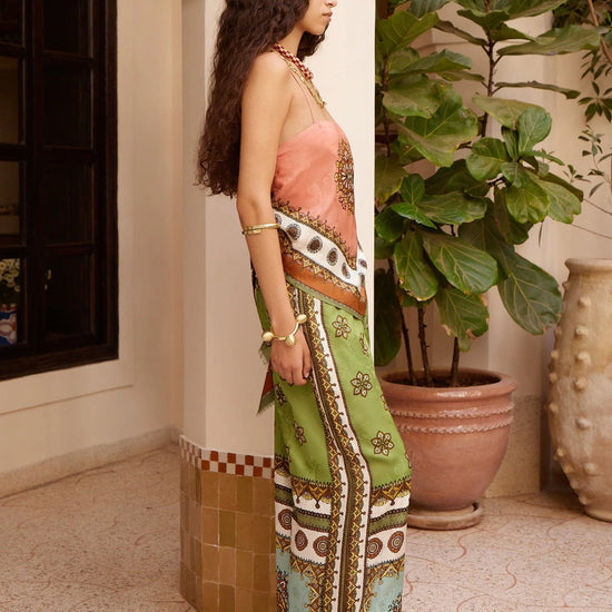 wide leg silk trousers with drawstring waistband and vibrant print from alemais side view