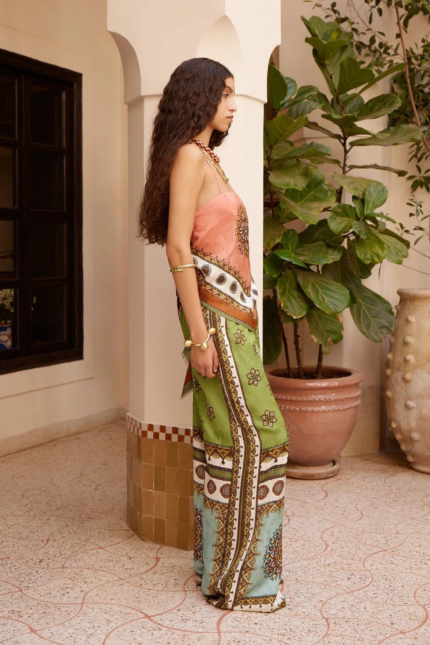 wide leg silk trousers with drawstring waistband and vibrant print from alemais side view