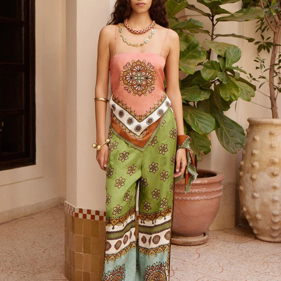 wide leg silk trousers with drawstring waistband and vibrant print from alemais model shot