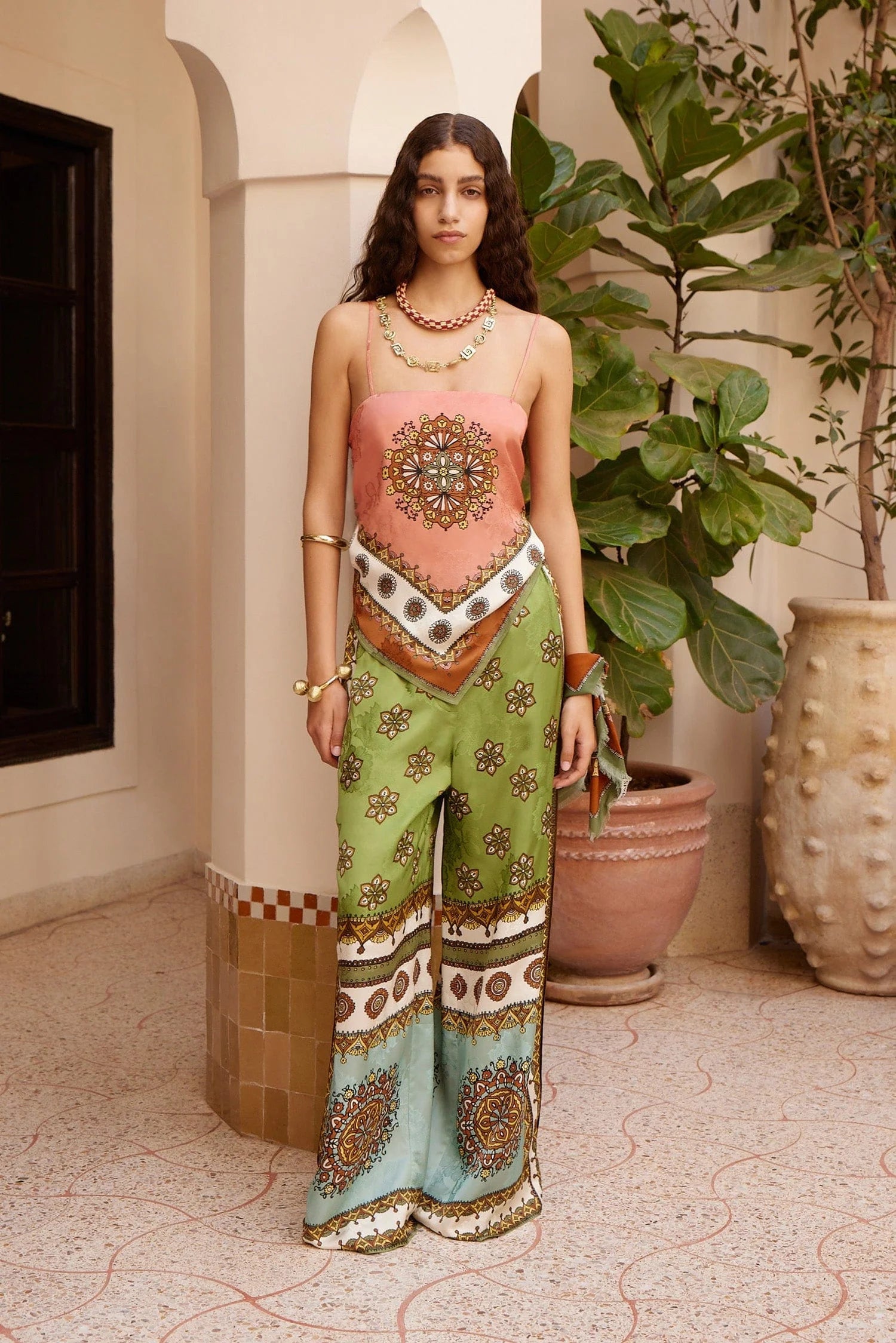 wide leg silk trousers with drawstring waistband and vibrant print from alemais model shot