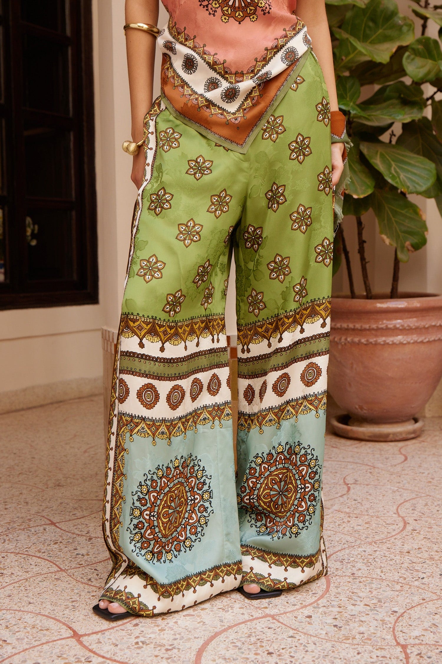 wide leg silk trousers with drawstring waistband and vibrant print from alemais model shot