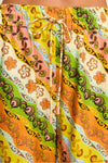 Colorful patterned shorts with a drawstring on a plain background