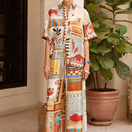 silk wide leg trousers with elasticated waistband and vibrant multi print from alemais model shot