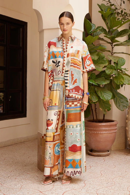 silk wide leg trousers with elasticated waistband and vibrant multi print from alemais model shot