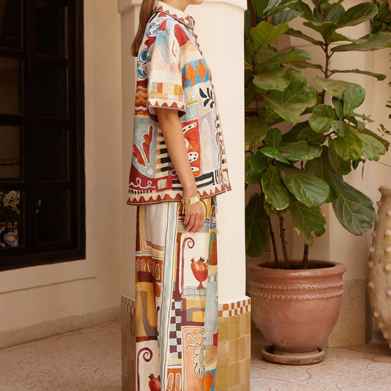 silk wide leg trousers with elasticated waistband and vibrant multi print from alemais side view