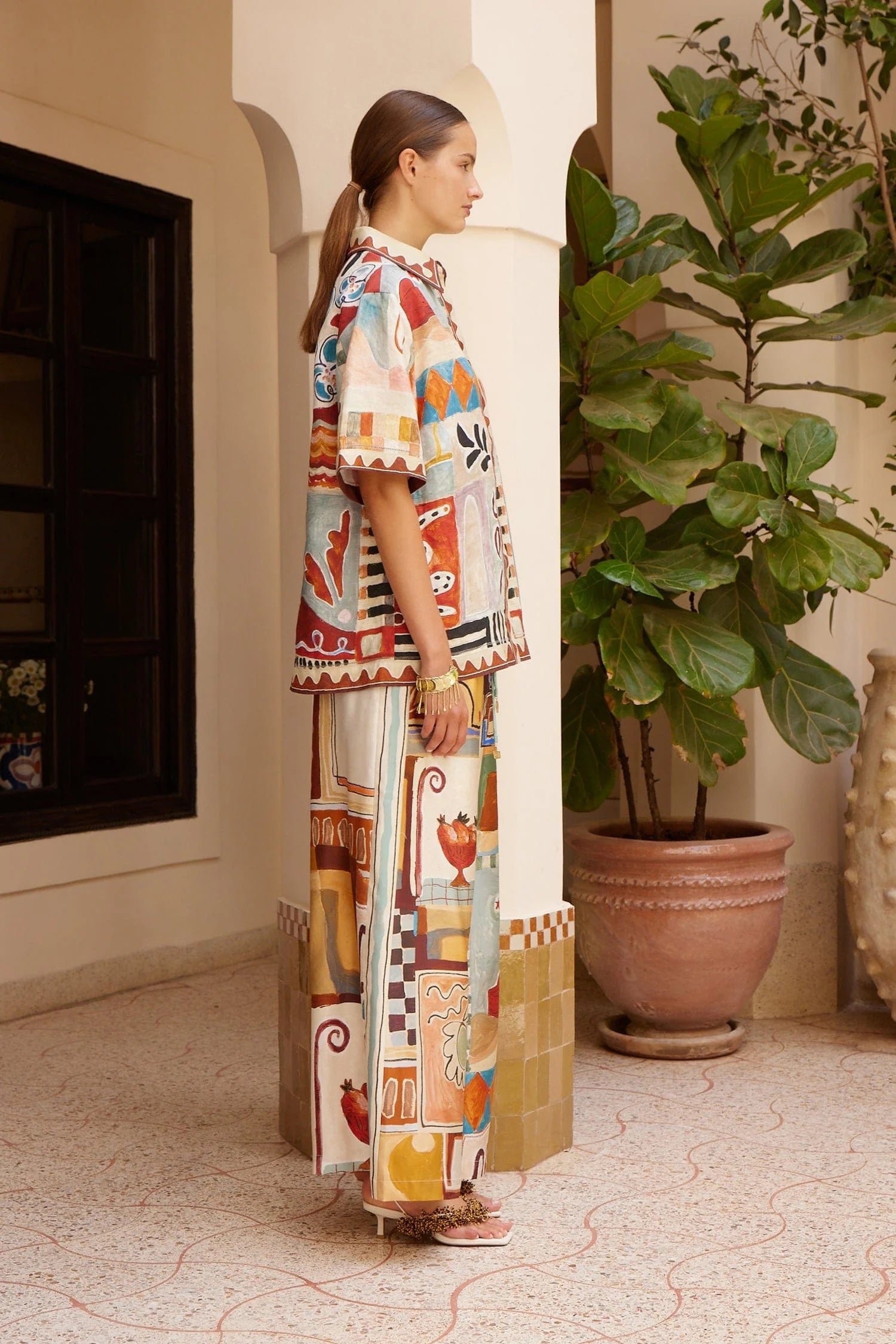 silk wide leg trousers with elasticated waistband and vibrant multi print from alemais side view