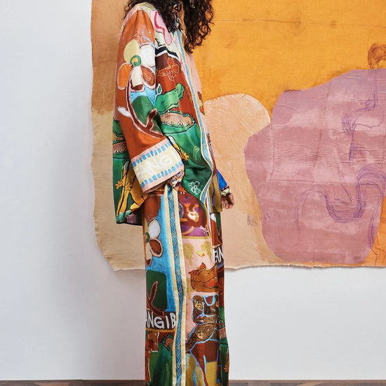 woman wearing Colourful patchwork trousers with floral and abstract patterns by Alemais side view
