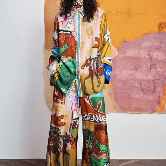 woman wearing Colourful patchwork trousers with floral and abstract patterns by Alemais 