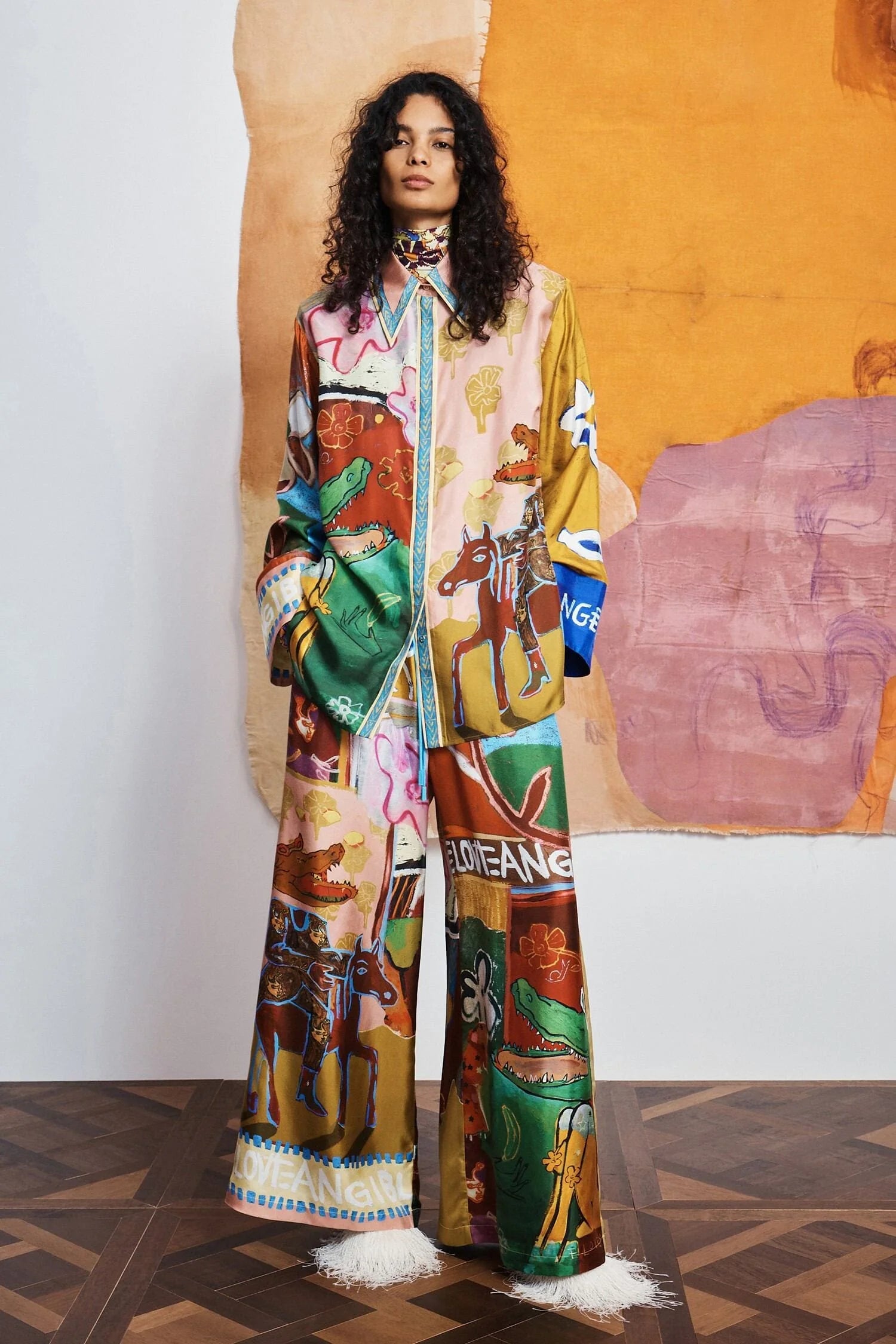 woman wearing Colourful patchwork trousers with floral and abstract patterns by Alemais 