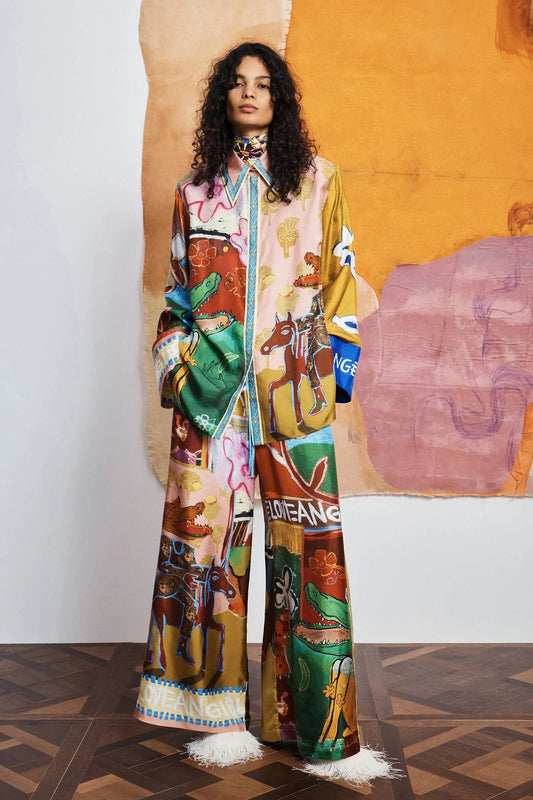 woman wearing Colourful patchwork trousers with floral and abstract patterns by Alemais 