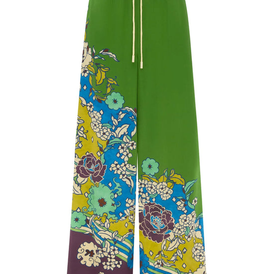 Green pants with colorful floral pattern BY Alemais on a white background.