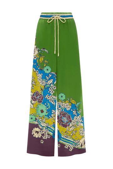 Green pants with colorful floral pattern BY Alemais on a white background.