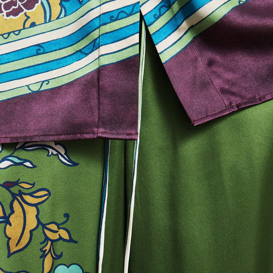 Close-up of a colorful fabric with floral patterns and stripes by Alemais.
