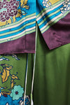 Close-up of a colorful fabric with floral patterns and stripes by Alemais.