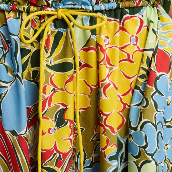 Colorful floral-patterned pants with a yellow drawstring.