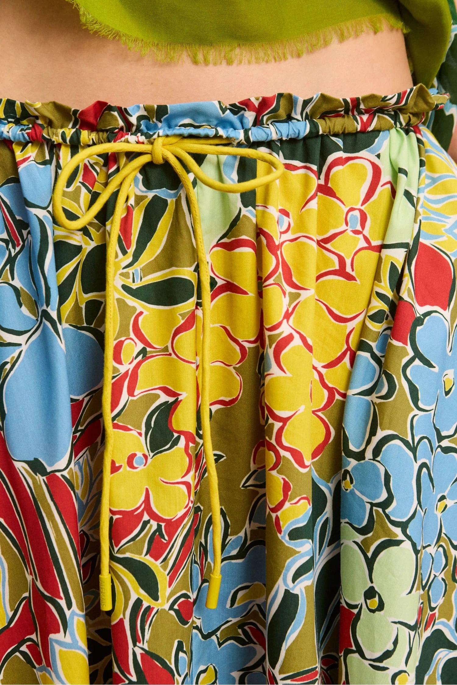 Colorful floral-patterned pants with a yellow drawstring.